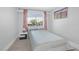 Well-lit bedroom featuring a full-sized bed, a large window, and hardwood flooring at 35 Spur Cross Cir, Henderson, NV 89012