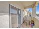 Balcony with sliding glass door, seating, plants, and nice neighborhood views at 3924 Quiet Pine St # 201, Las Vegas, NV 89108