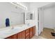 Bathroom featuring double sinks, wood vanity, and a mirror with lighting at 3924 Quiet Pine St # 201, Las Vegas, NV 89108