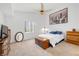 Bright bedroom featuring a ceiling fan, carpet, and dresser with a bed at 3924 Quiet Pine St # 201, Las Vegas, NV 89108