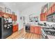 Kitchen featuring wooden cabinets, stainless steel appliances, and an open layout connected to adjacent spaces at 3924 Quiet Pine St # 201, Las Vegas, NV 89108