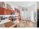 Bright kitchen with stainless steel appliances, wooden cabinets, and a cozy breakfast nook by the window at 3924 Quiet Pine St # 201, Las Vegas, NV 89108
