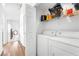 Bright laundry room features washer, dryer, storage shelves, and access to other rooms at 3924 Quiet Pine St # 201, Las Vegas, NV 89108