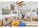 Spacious living room with hardwood floors, ample seating, and a ceiling fan for comfort at 3924 Quiet Pine St # 201, Las Vegas, NV 89108