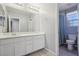 Bright bathroom with dual vanity, large mirror, and a separate toilet and shower area at 457 Cornelius Kelly Ave, Henderson, NV 89011