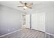 Bright bedroom featuring a ceiling fan, closet and an open door at 457 Cornelius Kelly Ave, Henderson, NV 89011