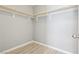 Walk-in closet featuring wood-look floors and installed hanging system at 457 Cornelius Kelly Ave, Henderson, NV 89011