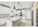 Well-appointed kitchen with stone countertops, a central island, and stainless steel appliances at 457 Cornelius Kelly Ave, Henderson, NV 89011