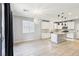 Bright kitchen with white cabinets, stainless steel appliances, pendant lighting and large island at 457 Cornelius Kelly Ave, Henderson, NV 89011