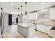 Bright kitchen with central island, stainless appliances, and seamless flow to the outdoor space at 457 Cornelius Kelly Ave, Henderson, NV 89011