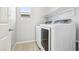 Well-lit laundry room with modern washer and dryer units and a convenient shelf at 457 Cornelius Kelly Ave, Henderson, NV 89011