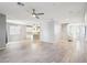 Spacious open-concept living area with sleek tile floors, modern lighting, and seamless flow to the kitchen at 457 Cornelius Kelly Ave, Henderson, NV 89011