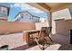 Covered brick patio featuring a wooden table and chairs, perfect for outdoor dining at 457 Cornelius Kelly Ave, Henderson, NV 89011