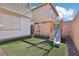This backyard is equipped with a swing set and slide at 457 Cornelius Kelly Ave, Henderson, NV 89011