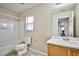 Bathroom features shower-tub combo, wood vanity and a large mirror at 4817 Eureka Diamond Ct, Las Vegas, NV 89139