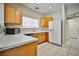 Functional kitchen features bright countertops, wood cabinets, and essential appliances for modern convenience at 4817 Eureka Diamond Ct, Las Vegas, NV 89139