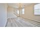 Bright living area leads to the stairs and entry with natural light creating an inviting, airy atmosphere at 4817 Eureka Diamond Ct, Las Vegas, NV 89139