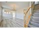 Bright living room showcasing wood-look flooring, chandelier lighting, and staircase at 4817 Eureka Diamond Ct, Las Vegas, NV 89139