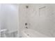 Bathroom featuring a shower/tub combo with marble-look tile and convenient built-in shelving at 539 Sellers Pl, Henderson, NV 89011