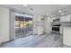This spacious kitchen boasts stainless steel appliances, white cabinetry, and grey wood-look flooring at 539 Sellers Pl, Henderson, NV 89011