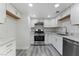 Modern kitchen featuring stainless steel appliances, white cabinets, and granite countertops at 539 Sellers Pl, Henderson, NV 89011