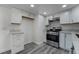 Stylish kitchen with stainless steel appliances, white cabinetry, and granite counters at 539 Sellers Pl, Henderson, NV 89011