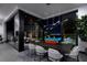 Sleek dining room with modern table, chairs, and expansive windows overlooking a pool and the city lights at 545 Overlook Rim Dr, Henderson, NV 89012
