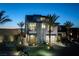 Striking modern two-story home with desert landscaping and integrated garage illuminated at twilight at 545 Overlook Rim Dr, Henderson, NV 89012