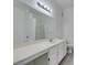 Bright bath with white vanity, large mirror, and vanity lighting at 5655 E Sahara Ave # 1060, Las Vegas, NV 89142