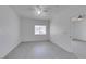 Well-lit bedroom with ceiling fan, window, and light gray flooring throughout at 5655 E Sahara Ave # 1060, Las Vegas, NV 89142