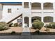 Condo building featuring a stucco facade, private balconies, and rock landscaping at its entryway at 5655 E Sahara Ave # 1060, Las Vegas, NV 89142