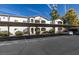 A bright two-story condo building with covered parking and manicured bushes at 5655 E Sahara Ave # 1060, Las Vegas, NV 89142