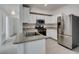 Modern kitchen features stainless steel appliances and white cabinets with updated finishes at 5655 E Sahara Ave # 1060, Las Vegas, NV 89142