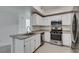 Bright kitchen features stainless steel appliances, white cabinets, and granite countertops at 5655 E Sahara Ave # 1060, Las Vegas, NV 89142