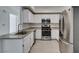 Well-lit kitchen offers stainless appliances, white cabinets, and modern countertops at 5655 E Sahara Ave # 1060, Las Vegas, NV 89142