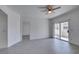 Open living room with light wood flooring, ceiling fan, neutral colors, and access to balcony at 5655 E Sahara Ave # 1060, Las Vegas, NV 89142