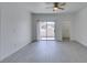 Open living room with light wood flooring, ceiling fan, neutral colors, and access to balcony at 5655 E Sahara Ave # 1060, Las Vegas, NV 89142