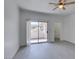 Bright living room with modern ceiling fan, neutral walls, wood-look floors, and access to balcony at 5655 E Sahara Ave # 1060, Las Vegas, NV 89142