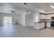 Open-concept living space with white cabinets, stainless steel appliances, and patio access at 5655 E Sahara Ave # 1060, Las Vegas, NV 89142