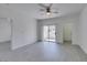 Bright living room with ceiling fan, neutral walls, wood-look floors, and access to balcony at 5655 E Sahara Ave # 1060, Las Vegas, NV 89142