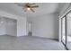 Bright living room with modern ceiling fan, neutral walls, wood-look floors, and slider doors at 5655 E Sahara Ave # 1060, Las Vegas, NV 89142