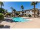 Inviting community pool with clear blue water, surrounded by palm trees and attractive landscaping at 5655 E Sahara Ave # 1060, Las Vegas, NV 89142