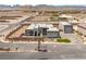 Expansive aerial view of a contemporary home with multiple garages, desert landscaping, and mountain backdrop at 5719 Christian Creek Ct, Las Vegas, NV 89149