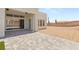 Beautiful back patio with brick pavers, large sliding glass doors, and stucco exterior at 5719 Christian Creek Ct, Las Vegas, NV 89149