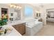 Bright bathroom features a modern tub, double sinks, and a separate shower with marble surround at 5719 Christian Creek Ct, Las Vegas, NV 89149