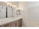 Modern bathroom featuring a quartz countertop, sleek vanity, and ample lighting near the walk-in shower at 5719 Christian Creek Ct, Las Vegas, NV 89149