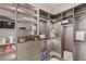 Organized walk-in closet with custom shelves, drawers, and rods for efficient storage at 5719 Christian Creek Ct, Las Vegas, NV 89149