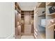 Spacious walk-in closet with custom shelving, drawers, and illuminated hanging rods at 5719 Christian Creek Ct, Las Vegas, NV 89149