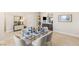 Bright open-concept dining area featuring hardwood floors, a glass table, and modern decor at 5719 Christian Creek Ct, Las Vegas, NV 89149