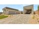 Spacious driveway leads to a three-car garage and desert-landscaped front yard at 5719 Christian Creek Ct, Las Vegas, NV 89149
